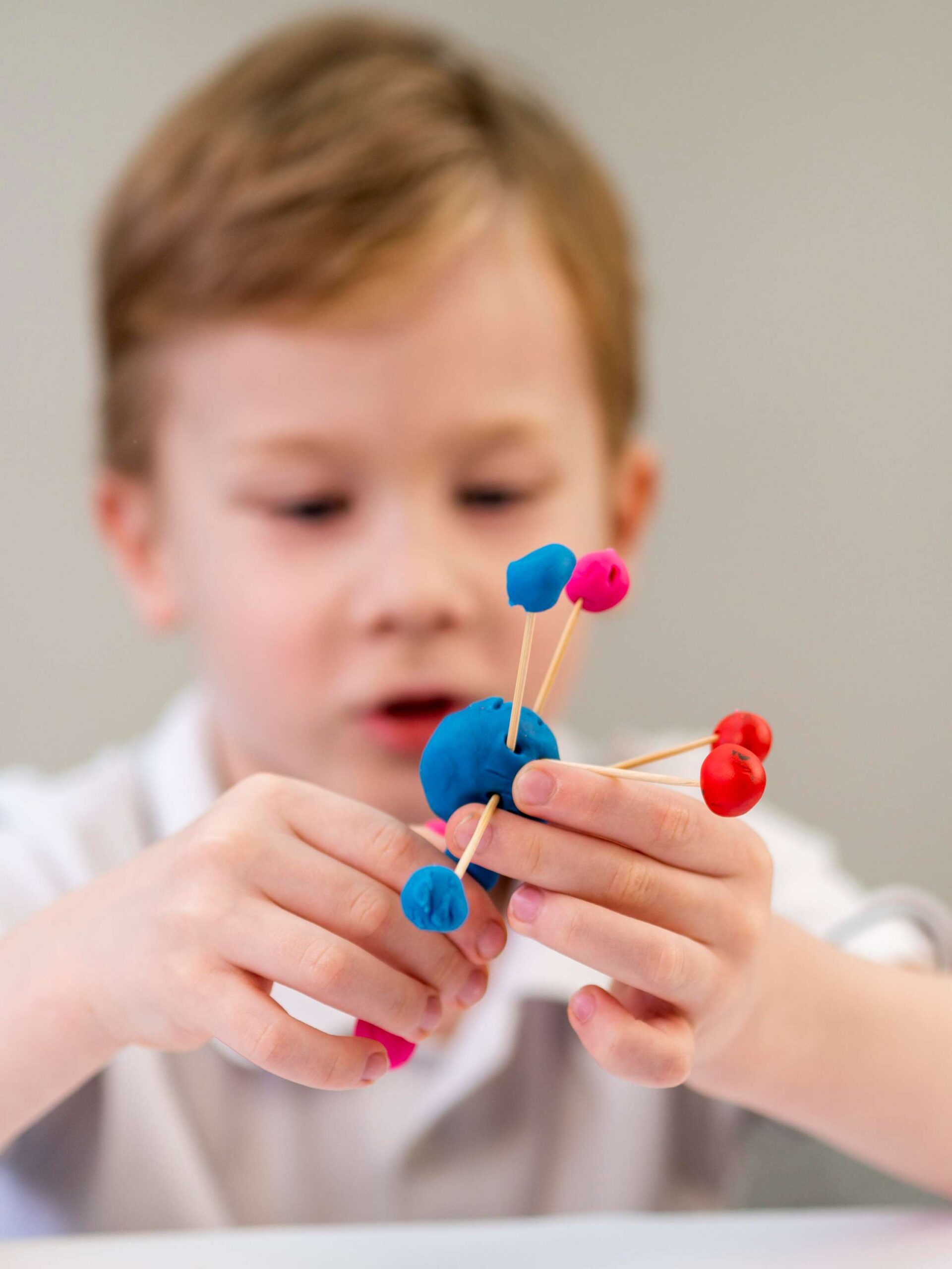 front-view-boy-playing-with-colorful-atoms-game (1)